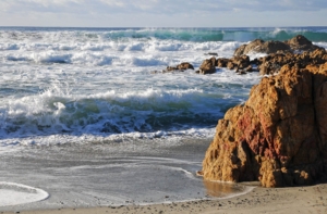 Turquoise waves crashing on the Ostriconi beach in Corsica.