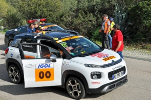 A security car in the Rally of Corsica is ensuring spectator's security.