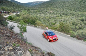 A car racing Corsican roads during FIA World Rally Championship.
