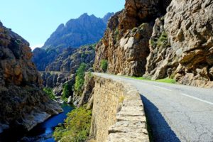 Sheer drop of the narrow road following the Golo river in the Scala di Santa Regina gorge.