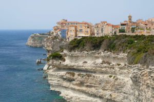 Medieval town of Bonifacio perched atop white limestone cliffs.