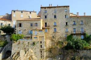 Tall granite buildings of Sartene perched strategically atop a rocky outcrop.