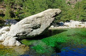 Eroded rock formations and grey granite boulders scattered along the canyon create natural slides and splashy waterfalls.