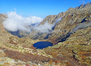 The trail affords panoramic views of flower-filled meadows and glistening glacial lakes.