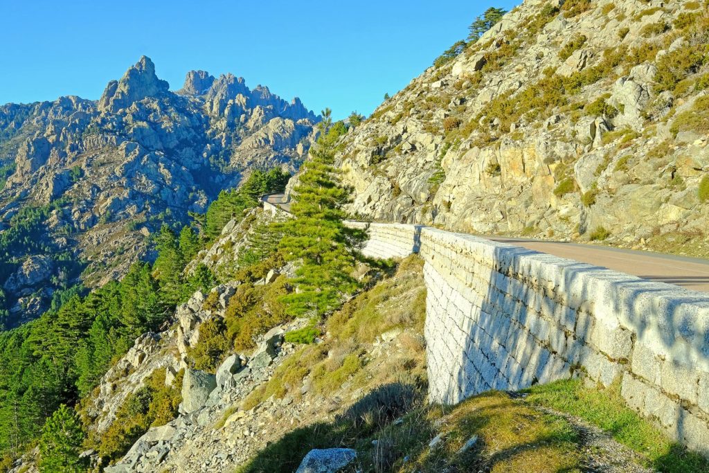 Aiguilles de Bavella are red granite spikes dominating a mountain pass of the same name.