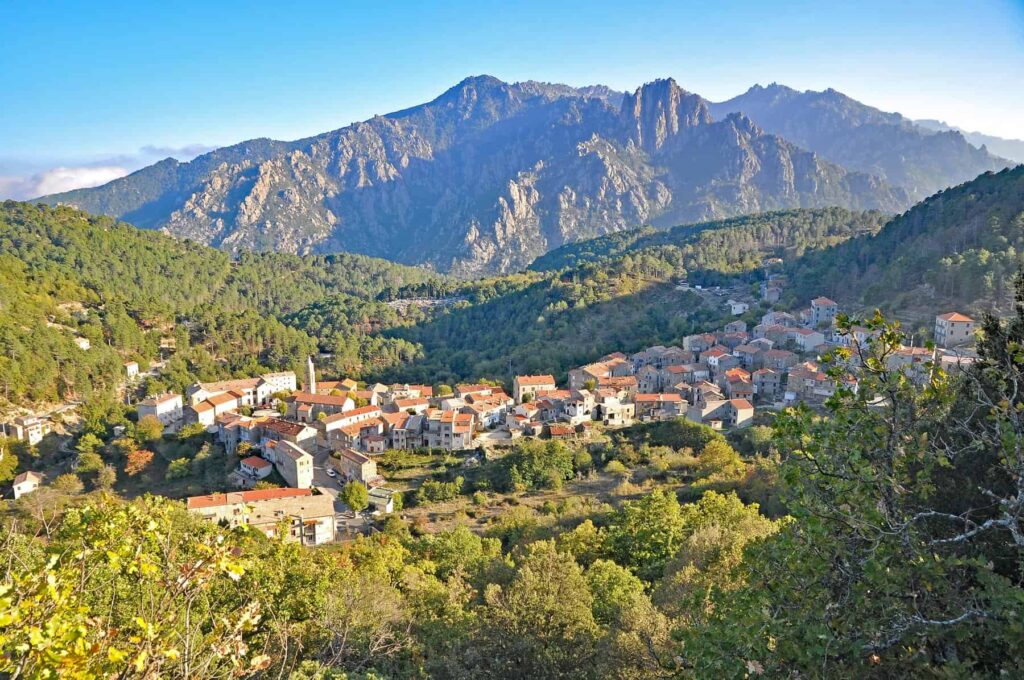 The historic Ghisoni village enjoys a supremely photogenic setting at the foot of rugged mountains.