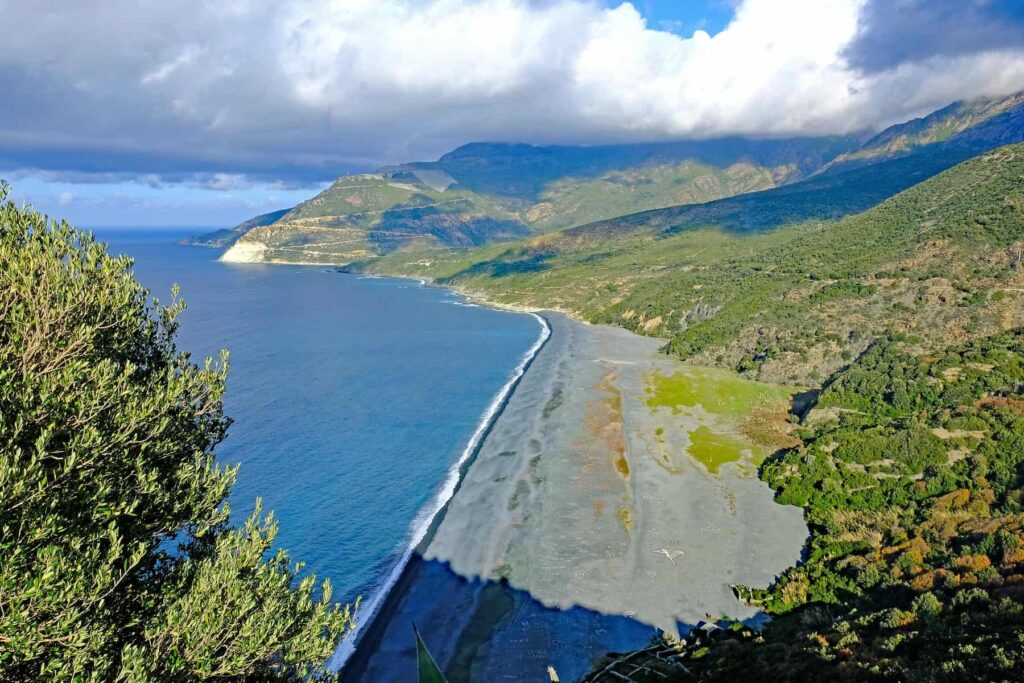 Nonza is famous for its dramatic black beach, narrow winding streets, and the historic tower that crowns the village.