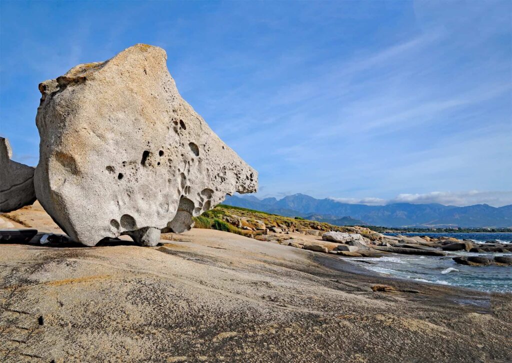 Punta Spano offers wild, untouched scenery where giant boulders frame small rocky coves.