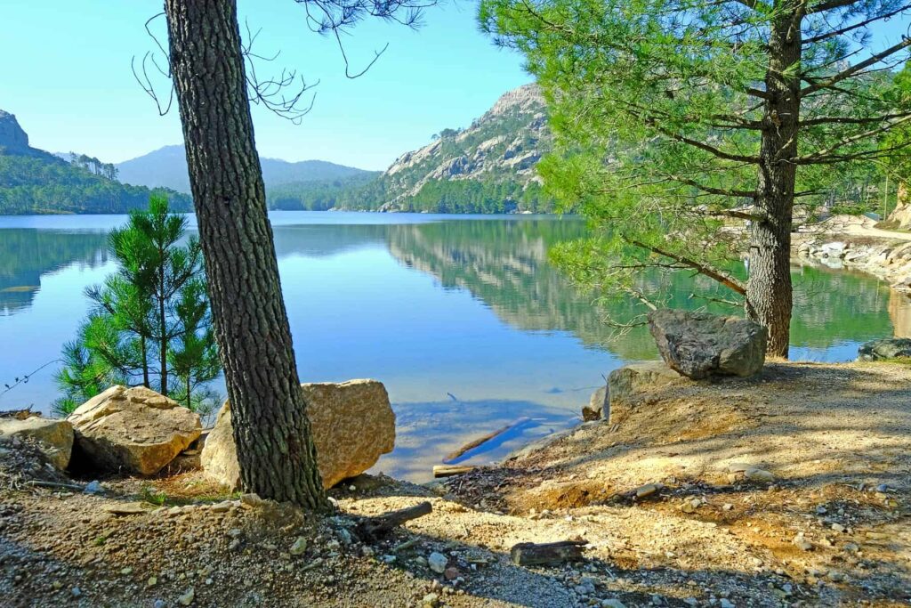 Winding past Ospedale Lake, the Bavella drive delights with a panorama of peaceful, lush surroundings.