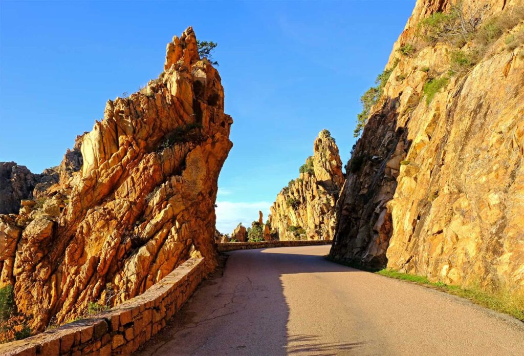 The stunning Calanches route follows a twisting course between narrow passages carved into sheer cliffs.