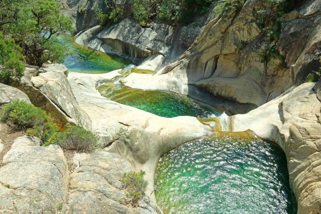 Known as the jewel of Bavella, Purcaraccia offers a thrilling outdoor adventure amid its cascading waterfalls and emerald pools.