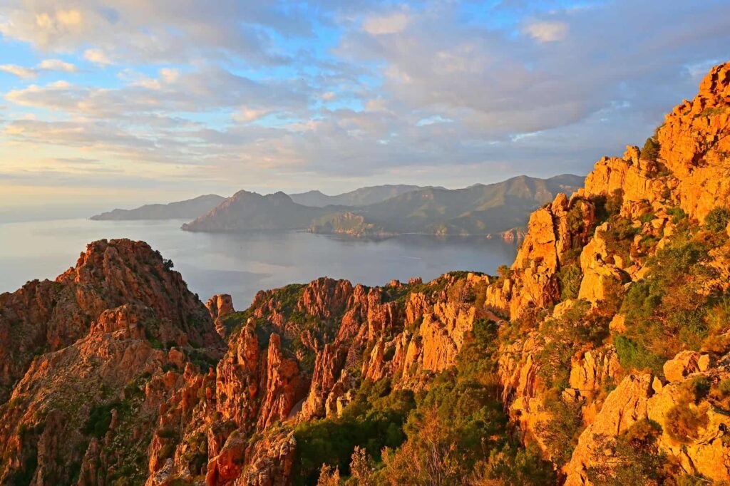 From the old mule trail in the Calanches, you can admire red granite wonders carved by time and elements.