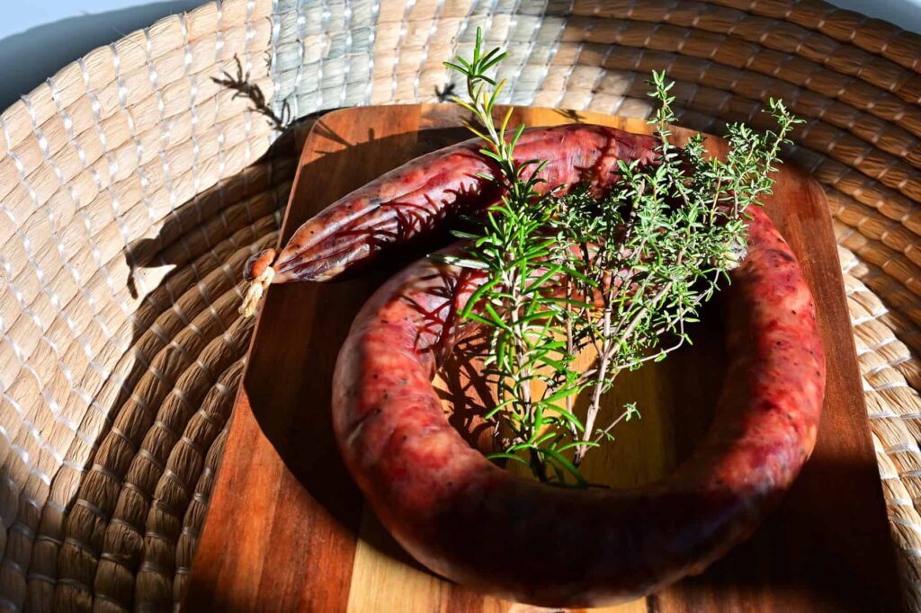 Grilled over vine branches, figatellu is traditionally served with chestnut flour polenta and brocciu.