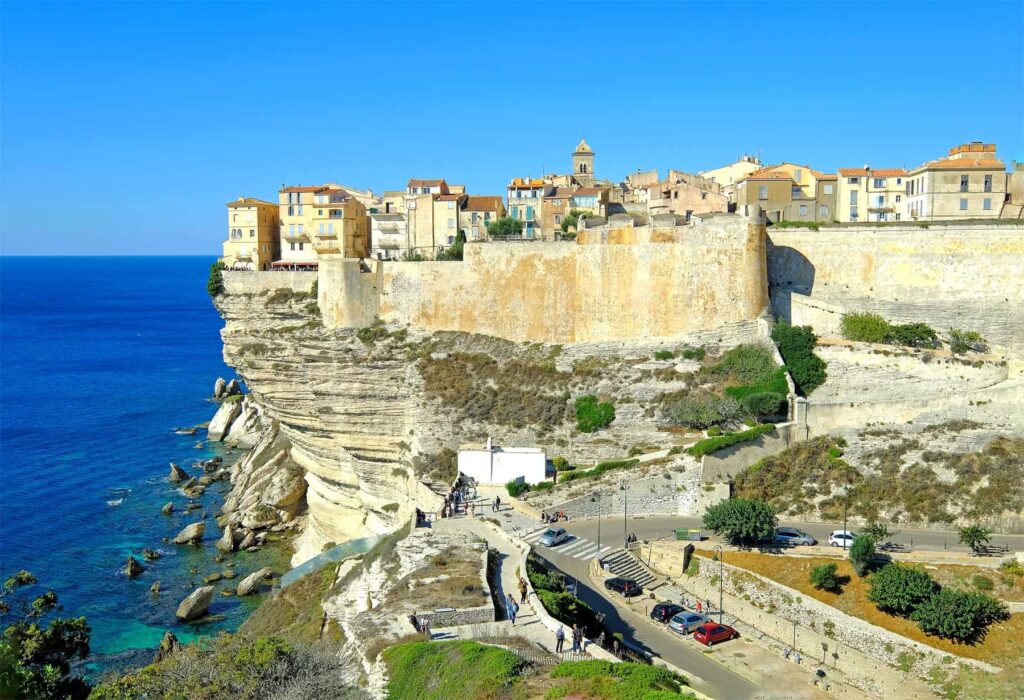 Bonifacio clings dramatically to white limestone cliffs above the sea on Corsica's southernmost tip.