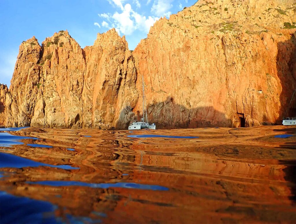 Discover the Gulf's volcanic cliffs, hidden coves, and crystal-clear waters from the sea.