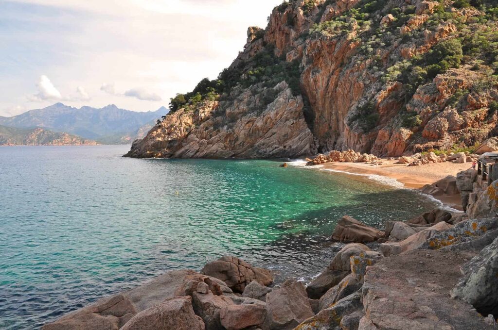 Hidden beneath towering cliffs, Ficaghjola is one of Corsica's most beautiful secret beaches.