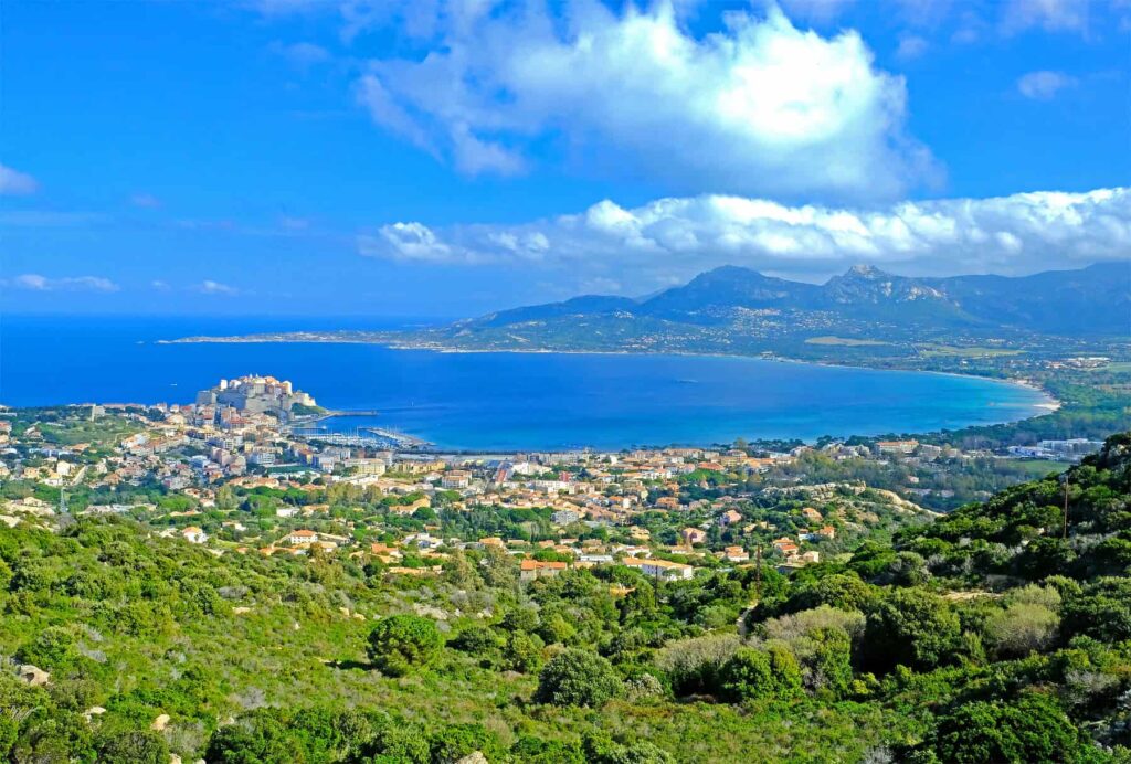 A sweeping panorama of Calvi Bay and the mountains of northern Corsica.